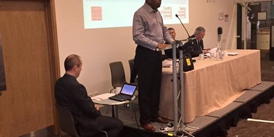 Prof Emmanuel Ogbonna, Lesley Griffiths AM, and Mr Ian Johnston PCC Gwent Police speaking…